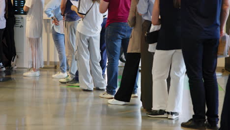 a line of people waiting indoors