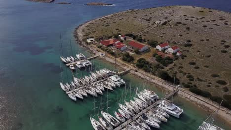 sailboats moored in marine piskera, kornati islands in croatia - aerial drone view