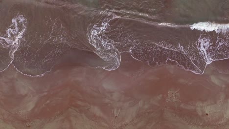 beautiful shallow swirling waves on a sandy orange and brown sandbar or shoal