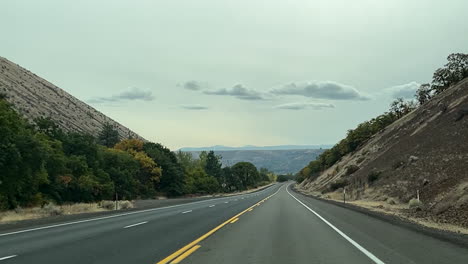 driving between hills in a remote area of oregon