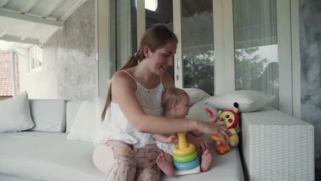 baby playing with toys with mom