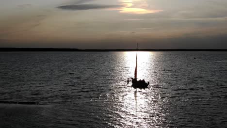 a group of friends about to set anchor during a sunset