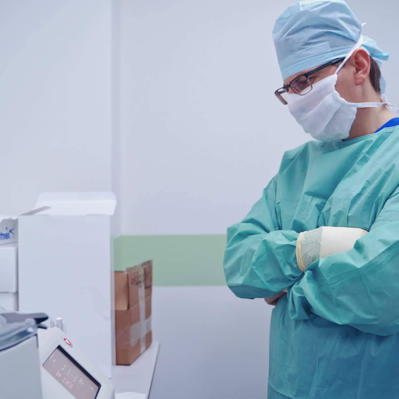 Stem cells research. Male doctor in mask standing near the new equipment for testing blood. Medical laboratory.