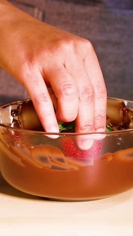 dipping strawberries in chocolate with sprinkles