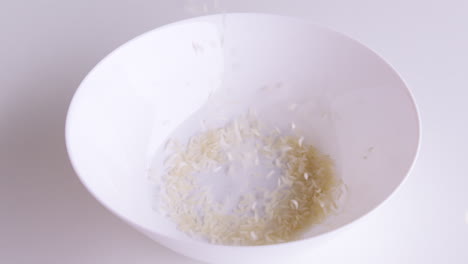 rice grains that have been cleaned of husks into bowls ready to be cooked and consumed, rice is the staple food of people in asia