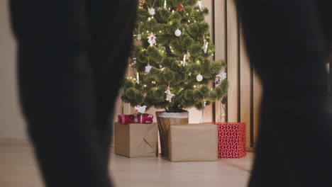 wrapped gifts under the christmas tree decorated with elements and christmas lights 2