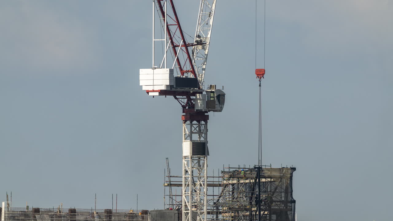 Construction Crane and Workers on a Building Site
