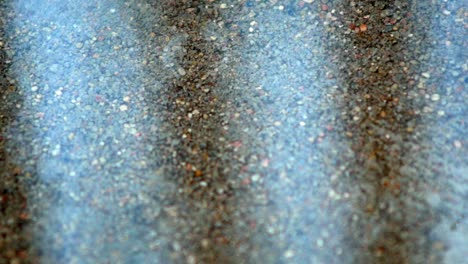 raindrops fall into water on concrete road and splashes