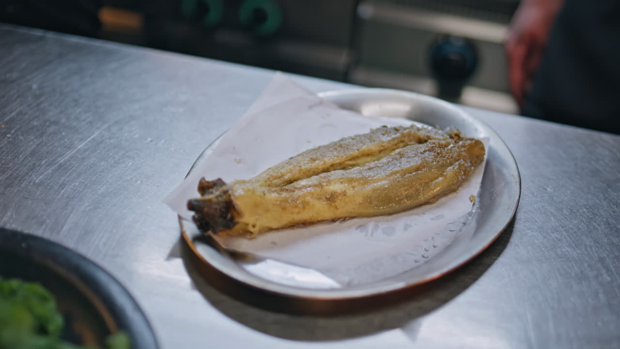 Professional chef hands cooking dish taking baked eggplant in kitchen closeup