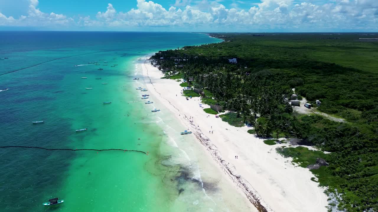 Drone aerial landscape of boats docked at sandy beach ocean coastline near Tulum ruins rainforest Mexico Central America travel tourism holidays sea National Park