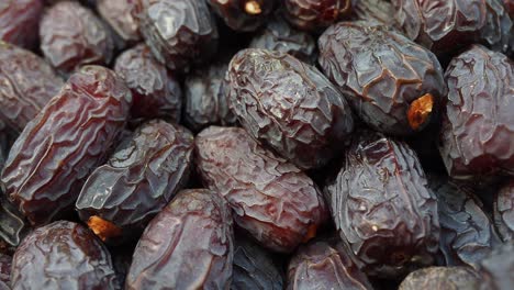 close-up view of a pile of dark, dried dates