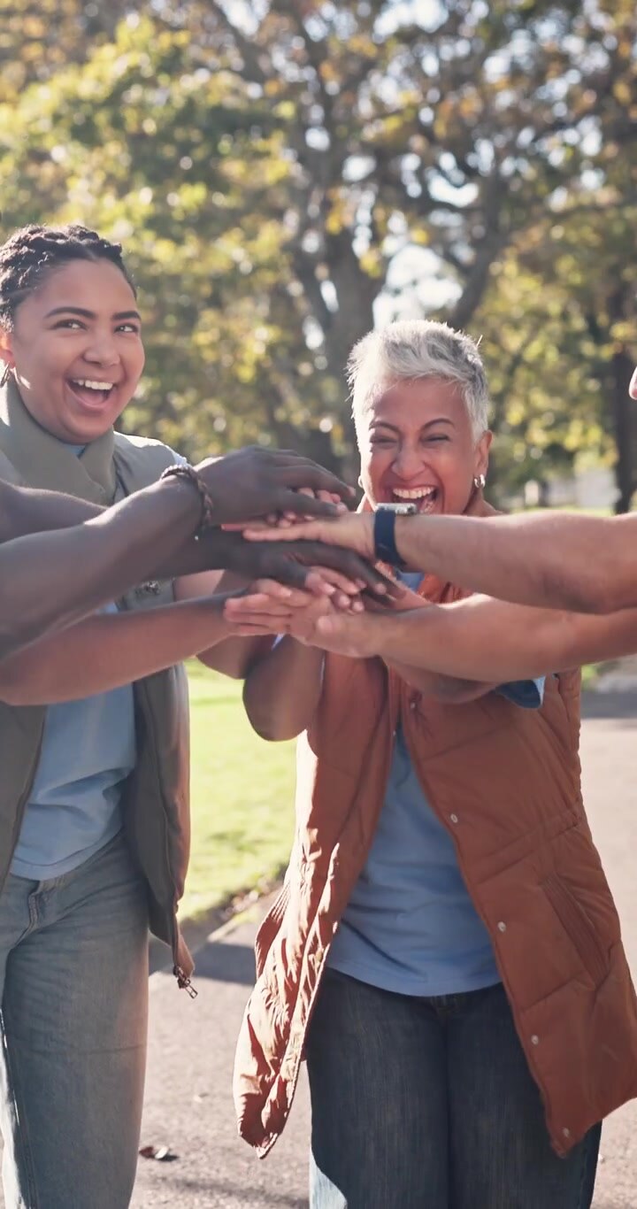 Diverse Group of Volunteers Celebrating Success Together in a Park