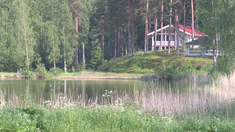 romantic lake or pond in finland with weekend house