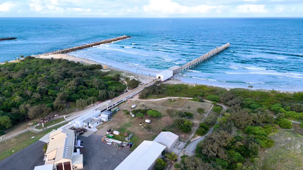 Drone captures pier and ocean waves