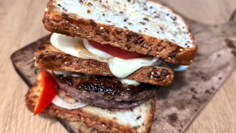 cutlet sandwich with three layers of grilled bread, close up view