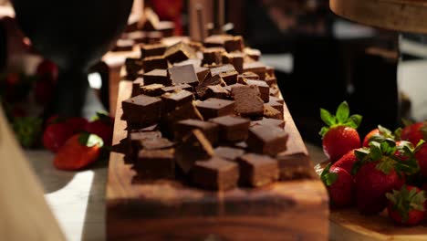picking up dark chocolate to eat
