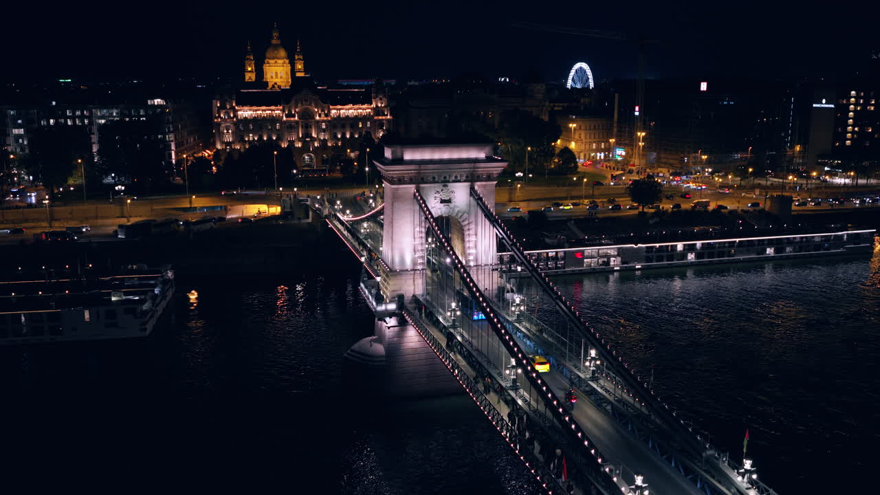 The Széchenyi Chain Bridge View From Above At Night Over The River Danube Between Buda And Pest In Budapest, Hungary. Aerial Shot
