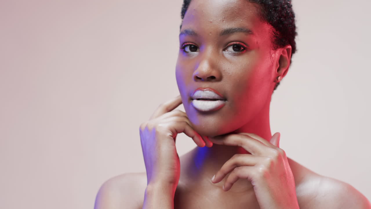African american woman with short dark hair in blue and pink light with copy space, slow motion
