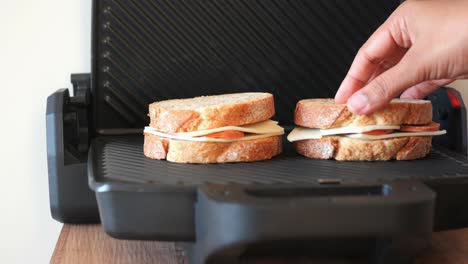 grilled cheese sandwich being prepared in a sandwich maker