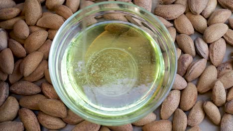 almond oil is poured into transparent bowl, view from above