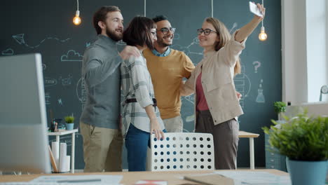 happy team taking a selfie in the office