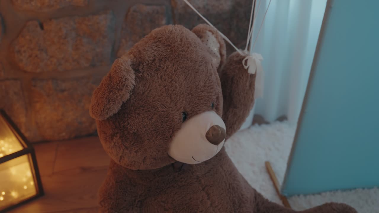 Cute plush teddy bear in cozy room with soft warm light ambiance