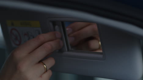 Opening-and-closing-the-sun-visor-in-a-car-with-mirror