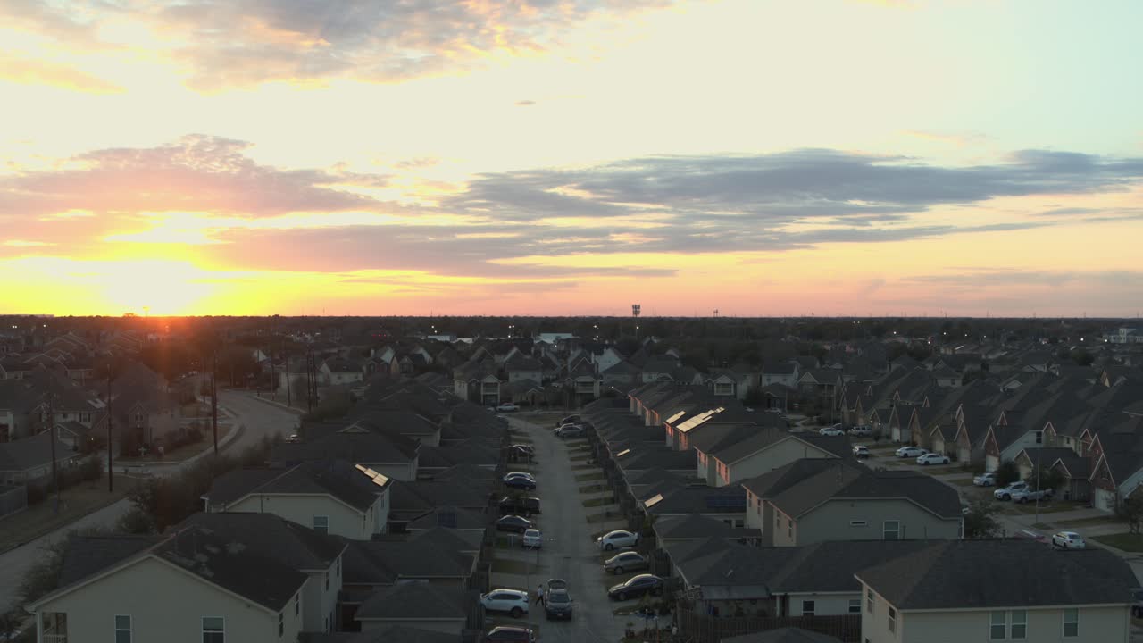 Smooth aerial drone footage of the Mission Bend residential neighborhood in west Houston, Texas, showing suburban homes and community layout during sunset