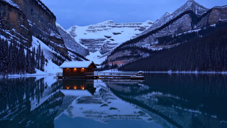 winter cabin on a mountain lake in the canadian rockies