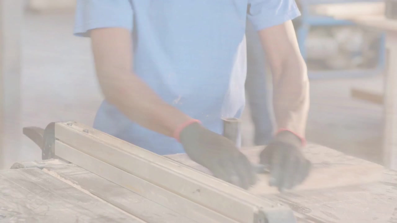 縦型動画：ガイドに板を置き、水色のシャツを着た男性が工具で切断するために作業台でマーキングしている。