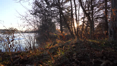 Pan-shot-of-a-frozen-lake-in-winter-by-sunset