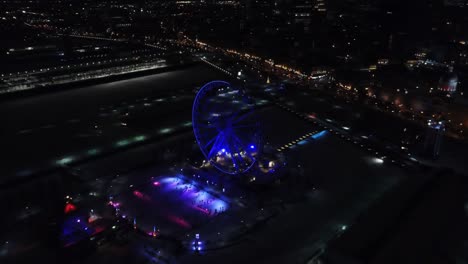 aerial clip of a ferris wheel during the night in montreal, canada