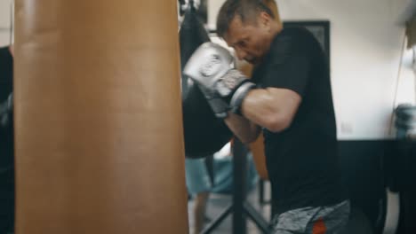 man hitting large punch bag