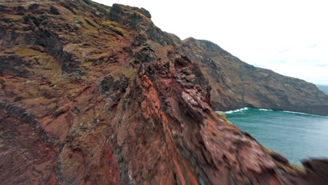 fpv drone flies over rocky coastline in la palma, canaries, exploring nature