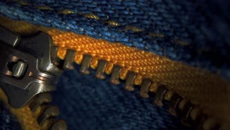 Denim-material-with-yellow-base-golden-zip-macro-close-up