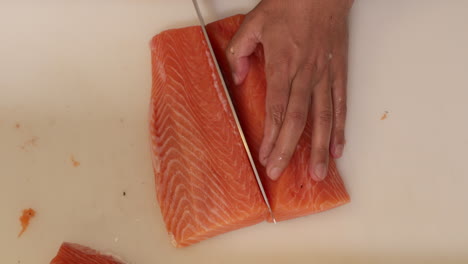 Slicing-fresh-salmon-for-a-delicious-Sushi-meal---close-up-slowmo