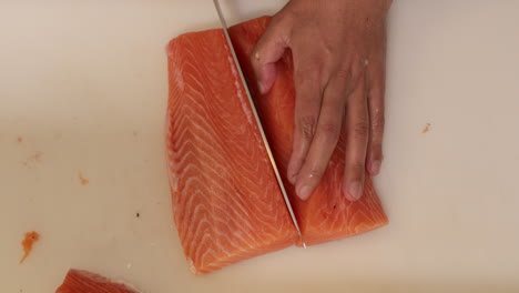 slicing fresh salmon for a delicious sushi meal - close up slowmo