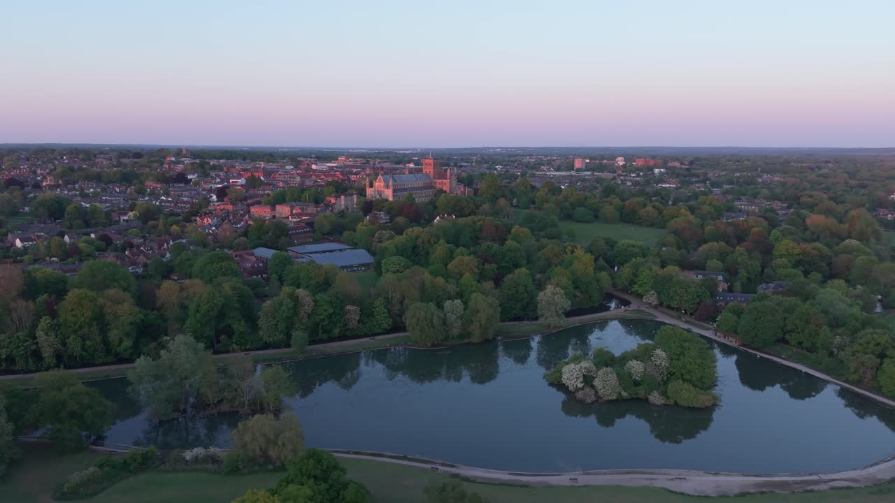 A cinematic drone orbits over St Albans, a picturesque London suburb, capturing its historic architecture, urban layout, and surrounding landscape in a breathtaking aerial view
