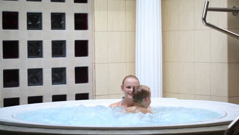 mother enjoying a spa bath with her son