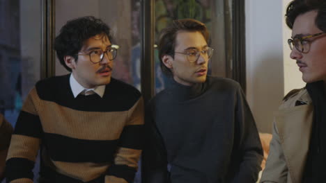 portrait of young businessmen talking in cafe. friends spending time together