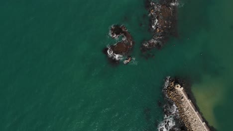 Aerial-view-above-a-grounded-ship-on-skerries-in-Tel-aviv,-Israel---top-down,-drone-shot