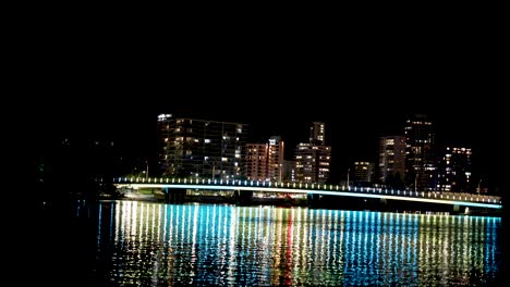 city lights reflecting on water at night