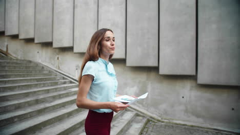 businesswoman walking downstairs in city