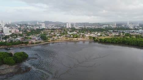 Aerial-across-tidal-mud-flat-to-Viejo-museum-and-park-in-Panama-City