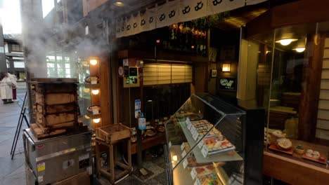 smoke billows from pot at sushi restaurant entrance