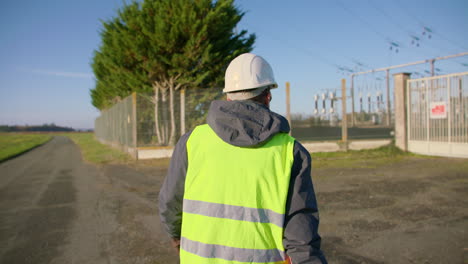 employee arriving at secured electrical installation location. slow-mo