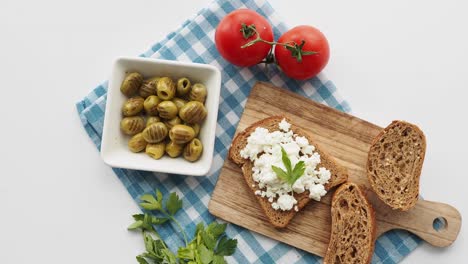 simple and healthy mediterranean breakfast: cottage cheese on whole wheat bread with olives and tomatoes