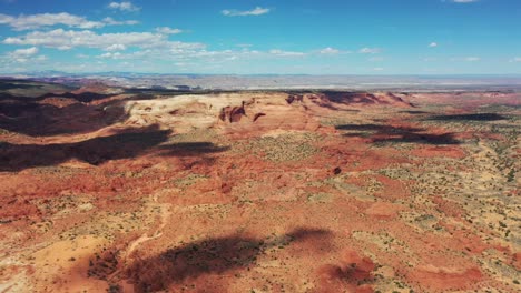 cinematic shot , aerial view of the rugged cliffs and desert landscape of utah near moab, usa