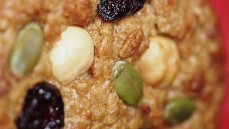 close-up of a homemade oatmeal cookie with nuts and seeds