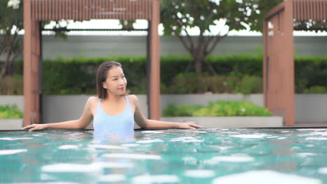 asian young woman taking spa at the hotel, smiles, and looks relaxed